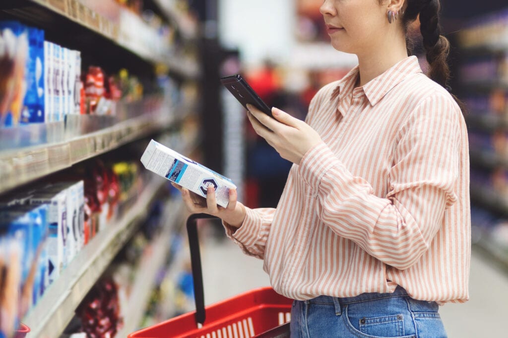 Woman scanning smartfacts qr code on packaging
