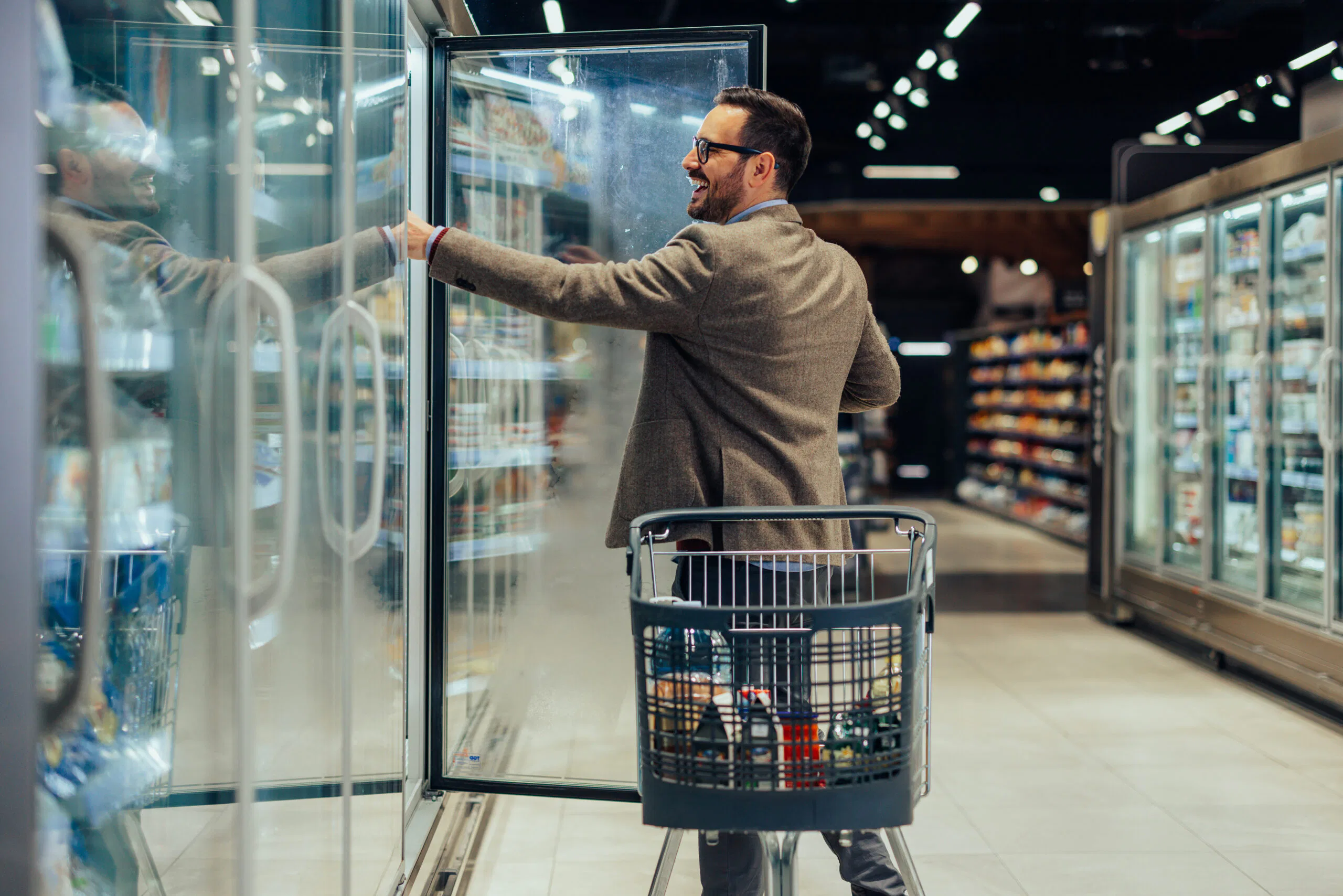 Man taking dairy products off the shelf